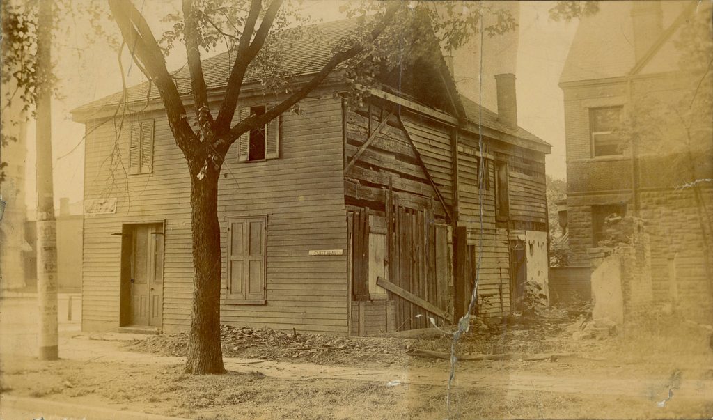side and rear view of cabin at its original location, main and monument
